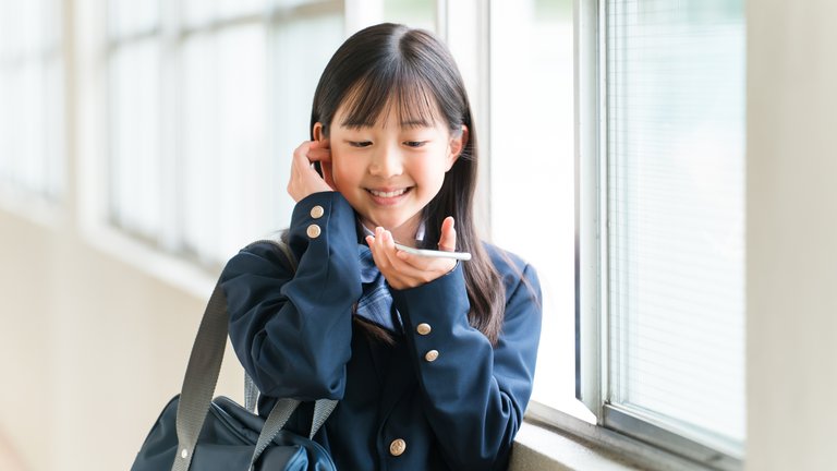 Girl talks to a chatbot through her mobile phone. Girl talks to a chatbot through her mobile phone.
