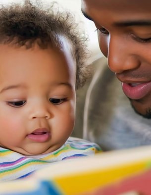 Father reading to his toddler son.