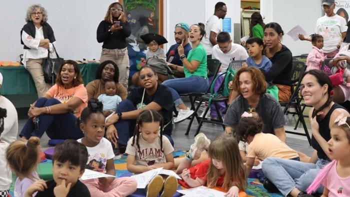 Families with young children gathered at an early literacy event.